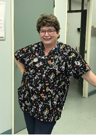 German veterinarian wearing her new scrub top with dogs
