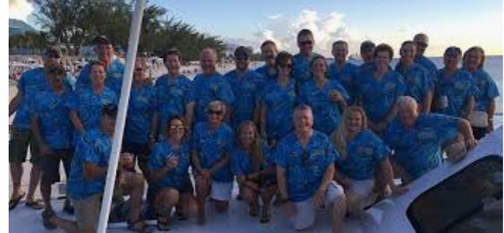 Physicians on trip to Grand Cayman on beach posing in animal print scrubs men and women