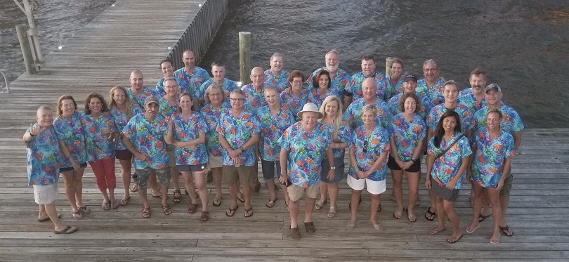 healthcareworkers on an island dock wearing animal print scrub tops on a trip