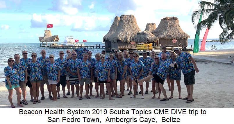 group of health care workers on beach in printed scrub tops
