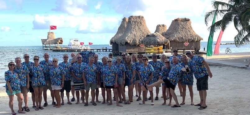 group of health care workers on beach in printed scrub tops