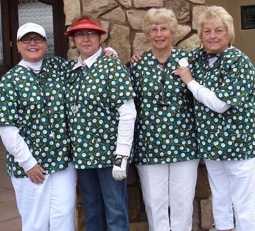 group of women golfers wearing matching scrub tops with golf design