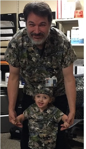 man and boy wearing matching scrub top uniforms