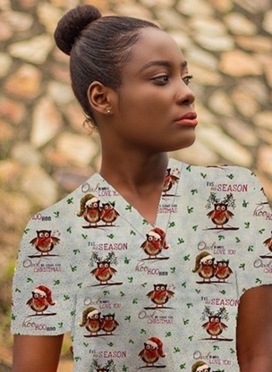 woman wearing festive holiday print scrub top with owls
