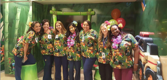 party of healthcare workers wearing unique print scrub tops with parrots