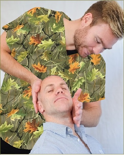 Man in green and brown scrubs adjusting another man's neck