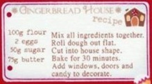 Festive red scrub top featuring gingerbread houses, cookies and recipes. Worn by model peeking from behind matching curtain.