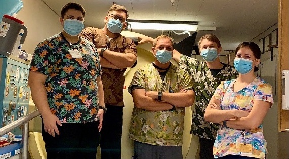 group of hyperbaric medicine workers wearing tropical print scrub tops on Aloha Friday