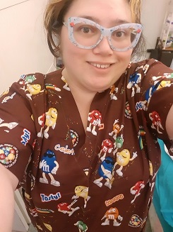 happy woman wearing unique cute candy print scrub top 